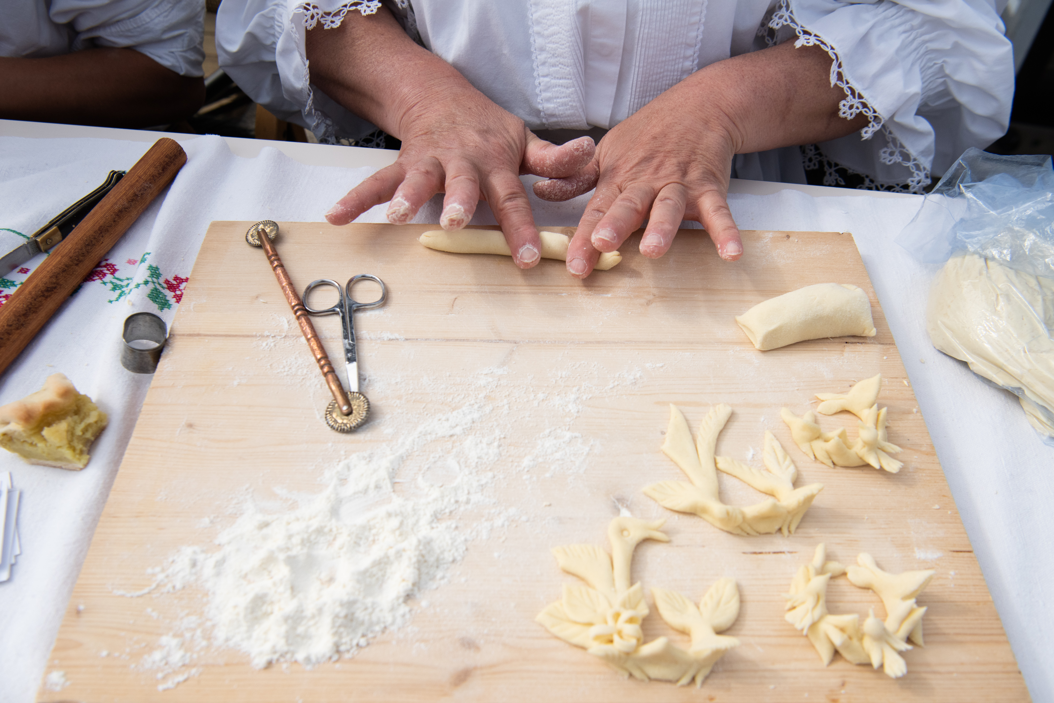 A person making decorations from bread dough